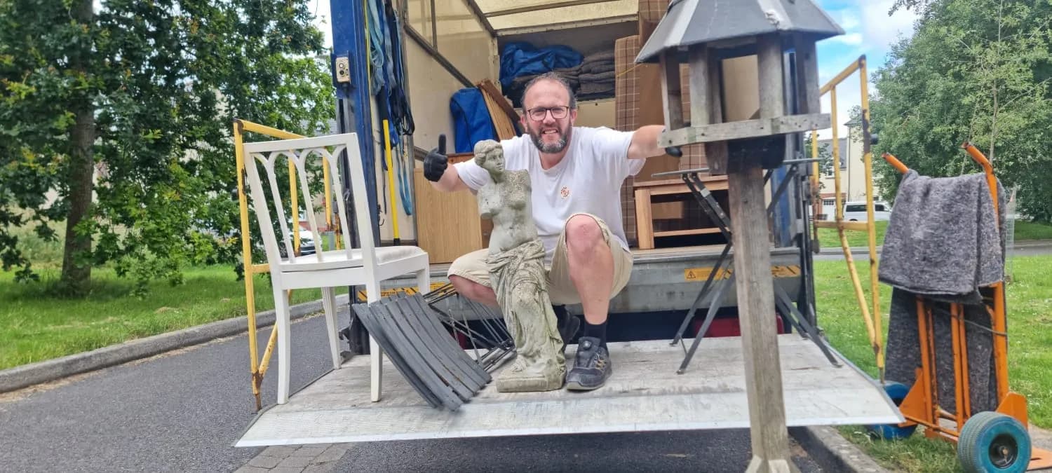 Eddy on the tail-lift of the Luton van with a carefully-loaded stone statue and garden furniture